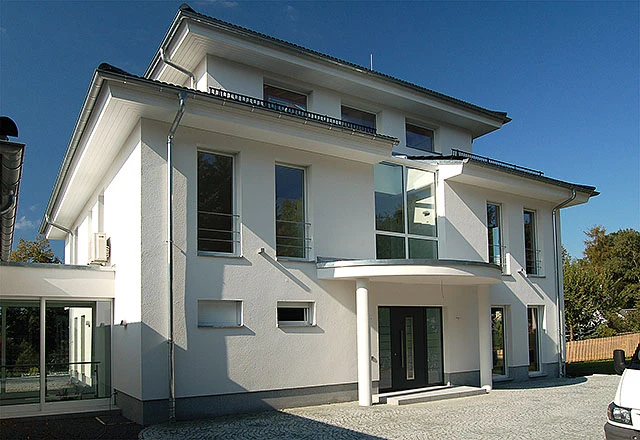Modernes weißes Neubau-Wohnhaus in Lengenfeld mit anthrazitfarbener Haustür und bodentiefen Fensterelementen